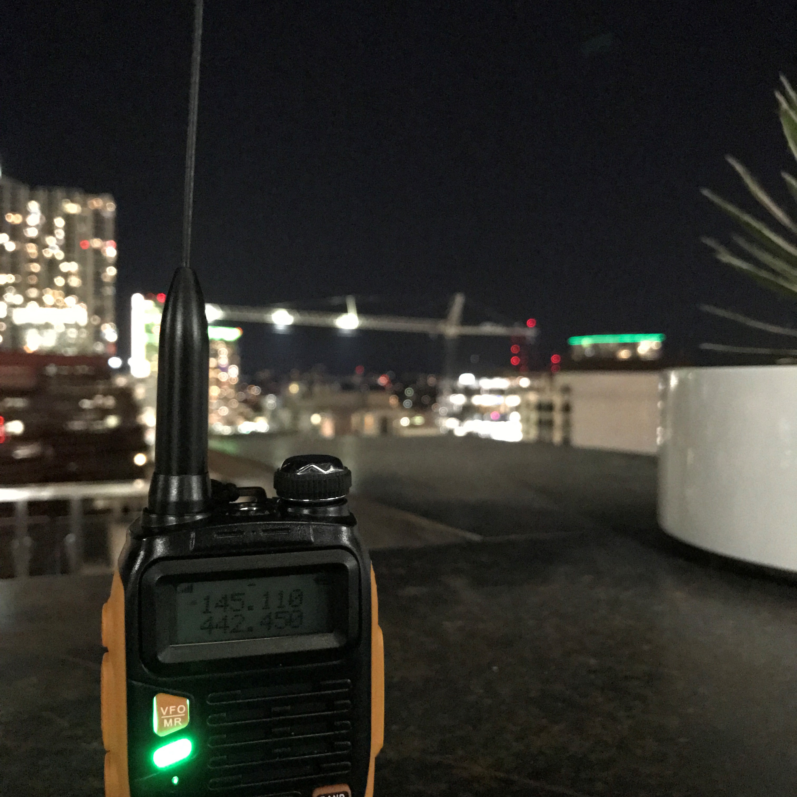 handheld radio with towers in background